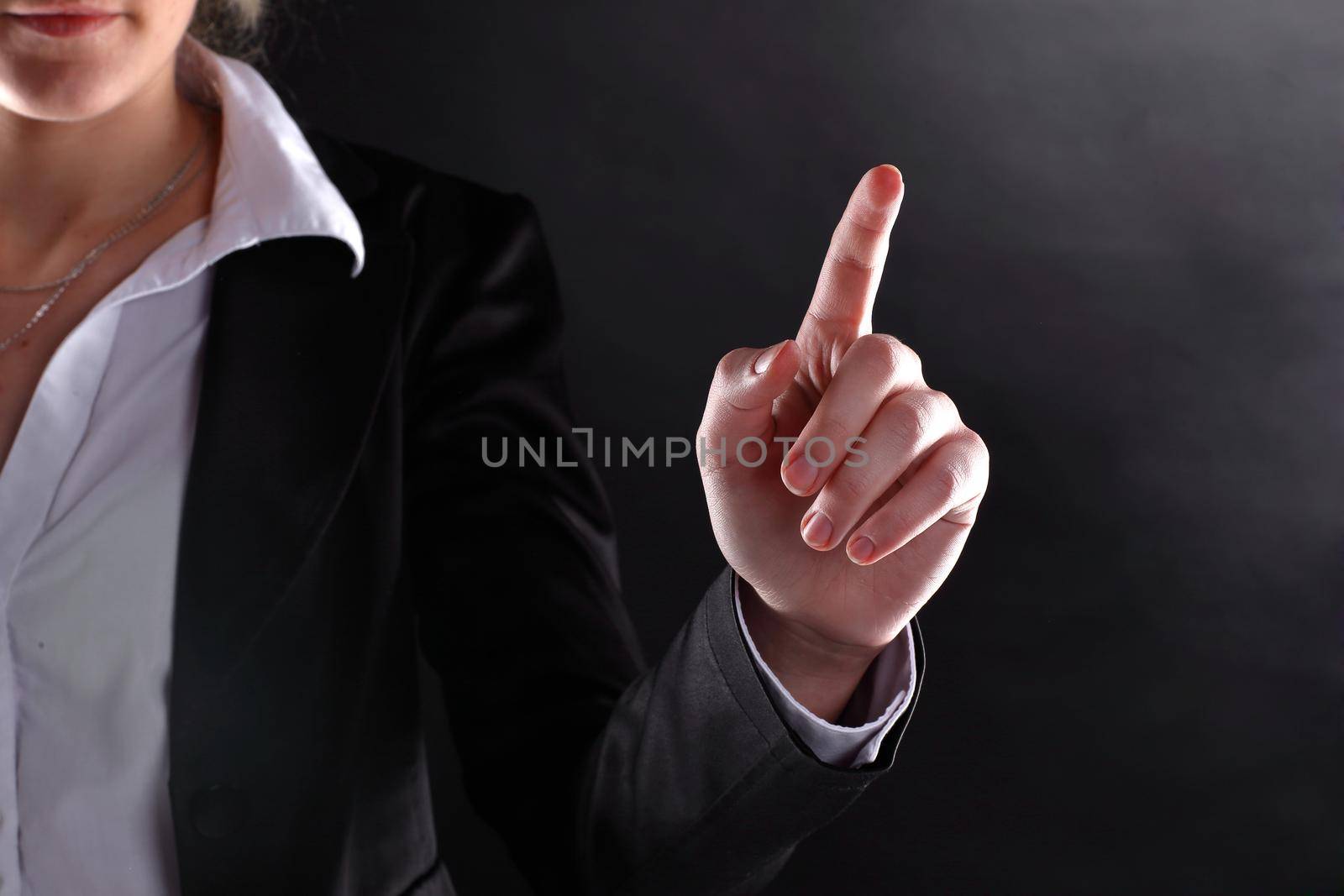 close up.business woman showing index finger up.isolated on black background by SmartPhotoLab