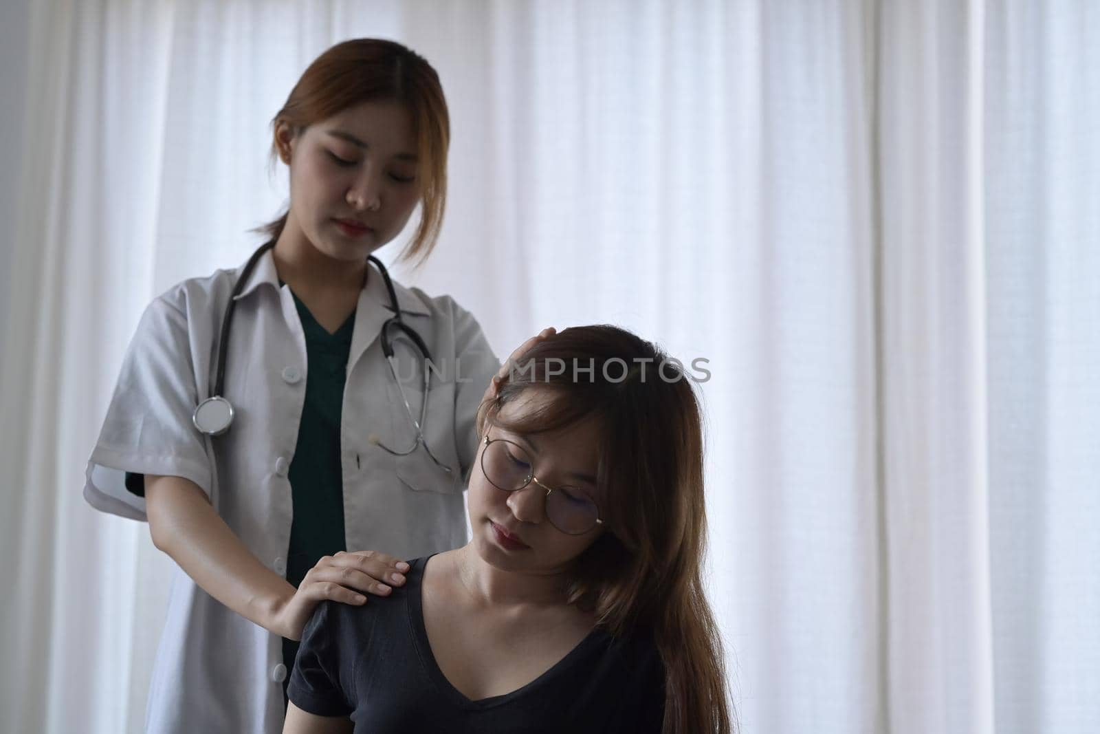 Professional physiotherapist examining female patient with neck injuries. Rehabilitation physiotherapy concept. by prathanchorruangsak