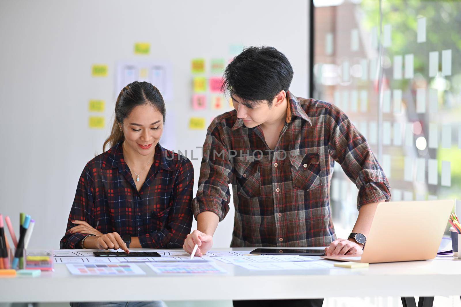 Shot of website developer team planning application development for mobile phone at creative workplace. by prathanchorruangsak