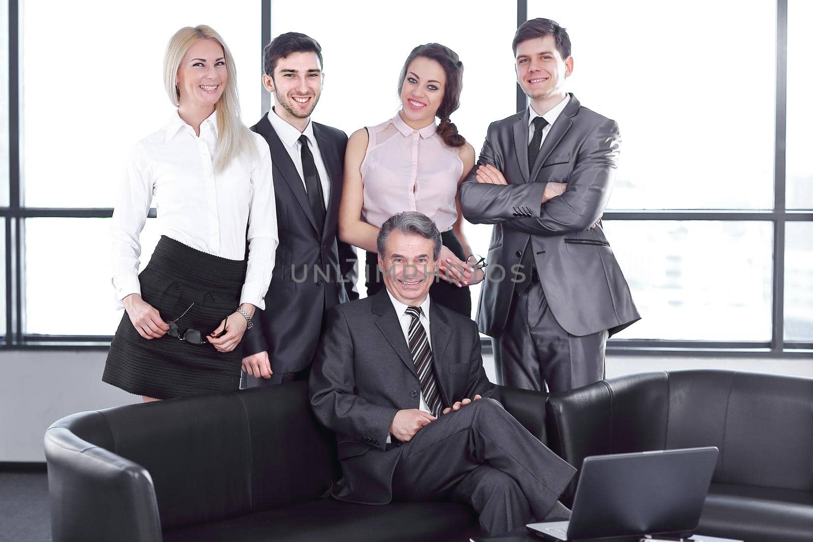 portrait of a businessman and business team in the office. the concept of a successful business