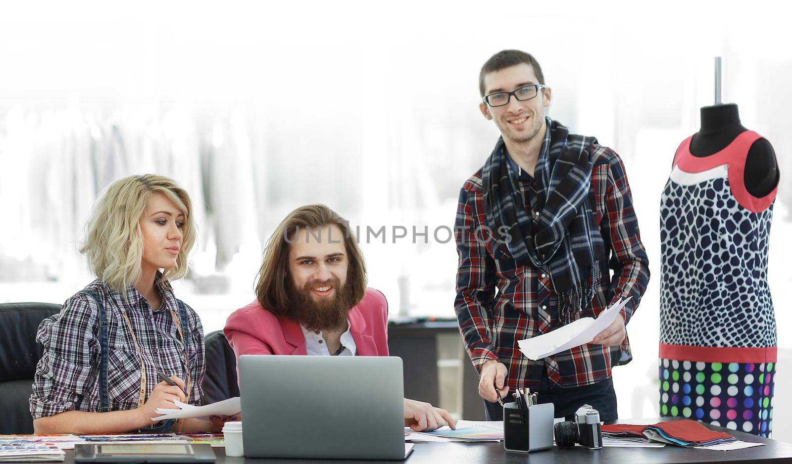 group of designers discussing new ideas in a modern Studio by SmartPhotoLab