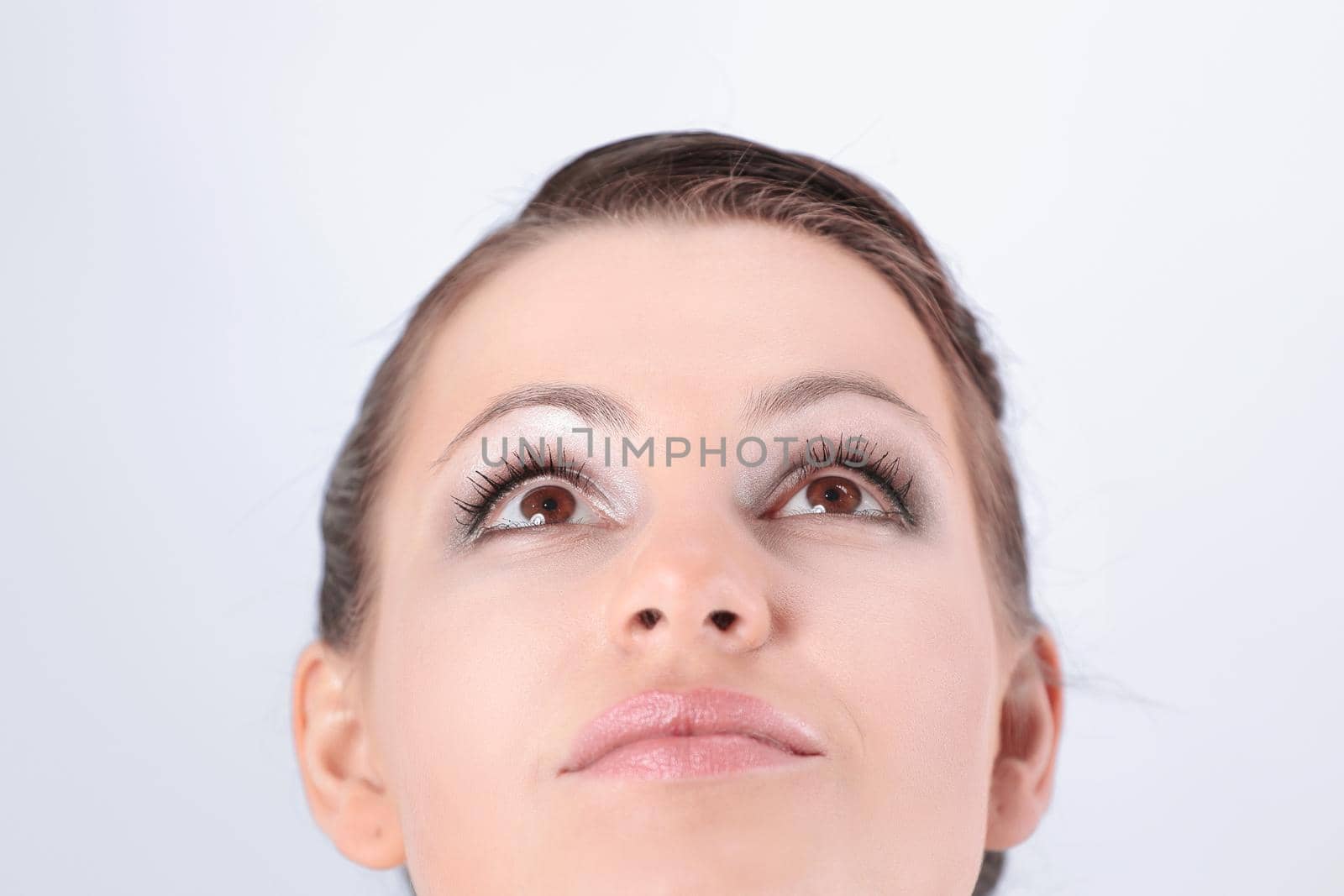 closeup. modern beautiful girl looking up at copy space.isolated on white background