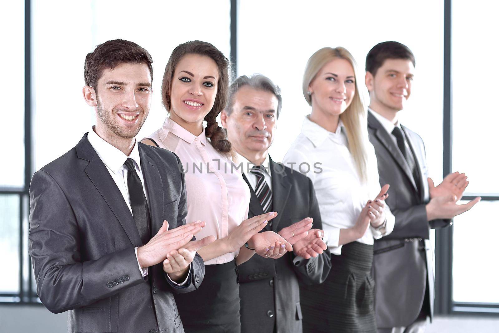 Successful business team applauding at the office. success concept