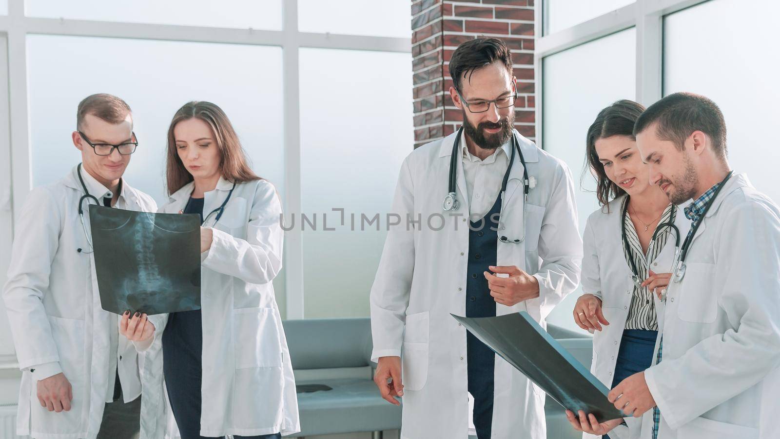 group of medical students discuss x-rays of patients by SmartPhotoLab