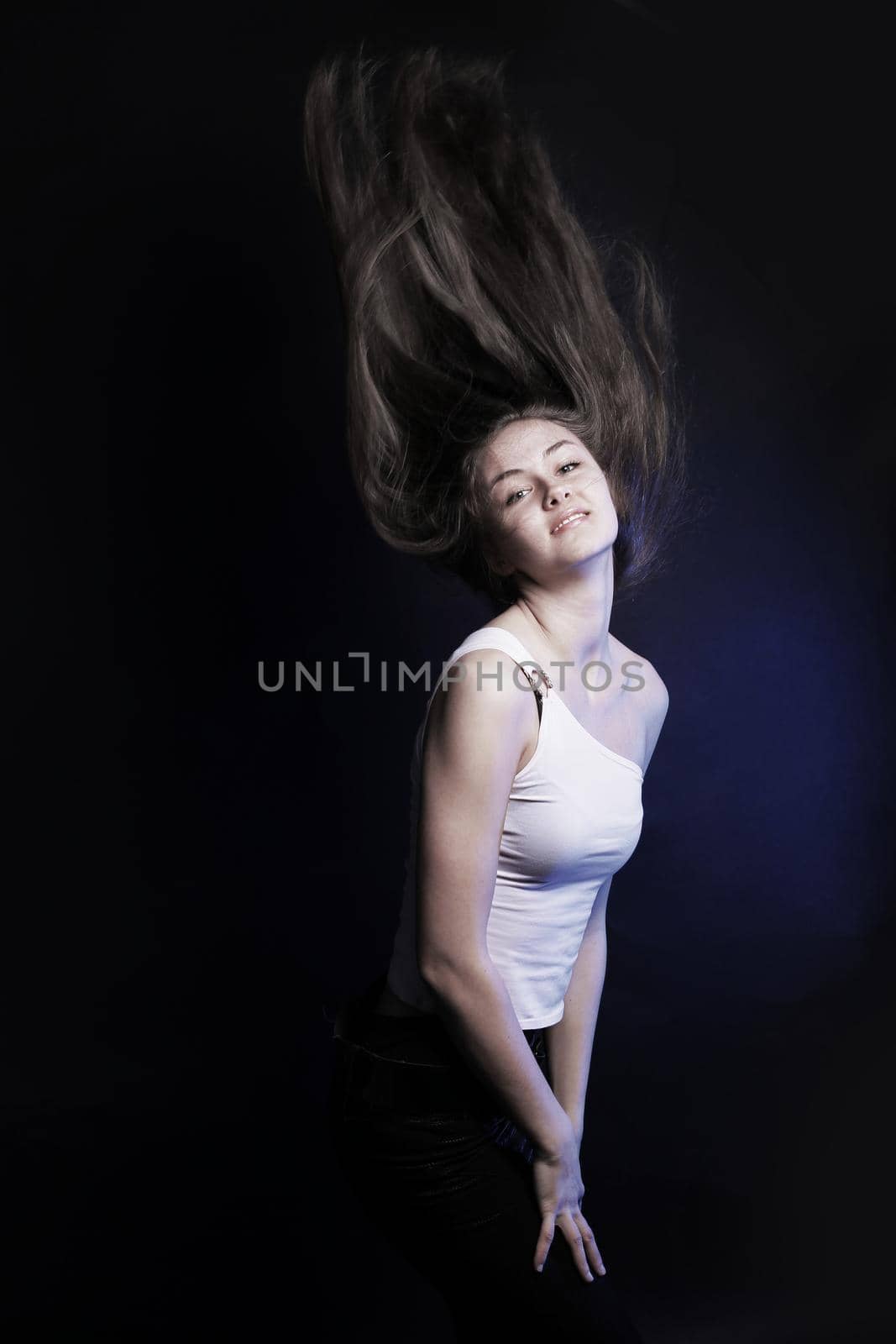 confident young woman with long hair .isolated on a black background. photo with copy space