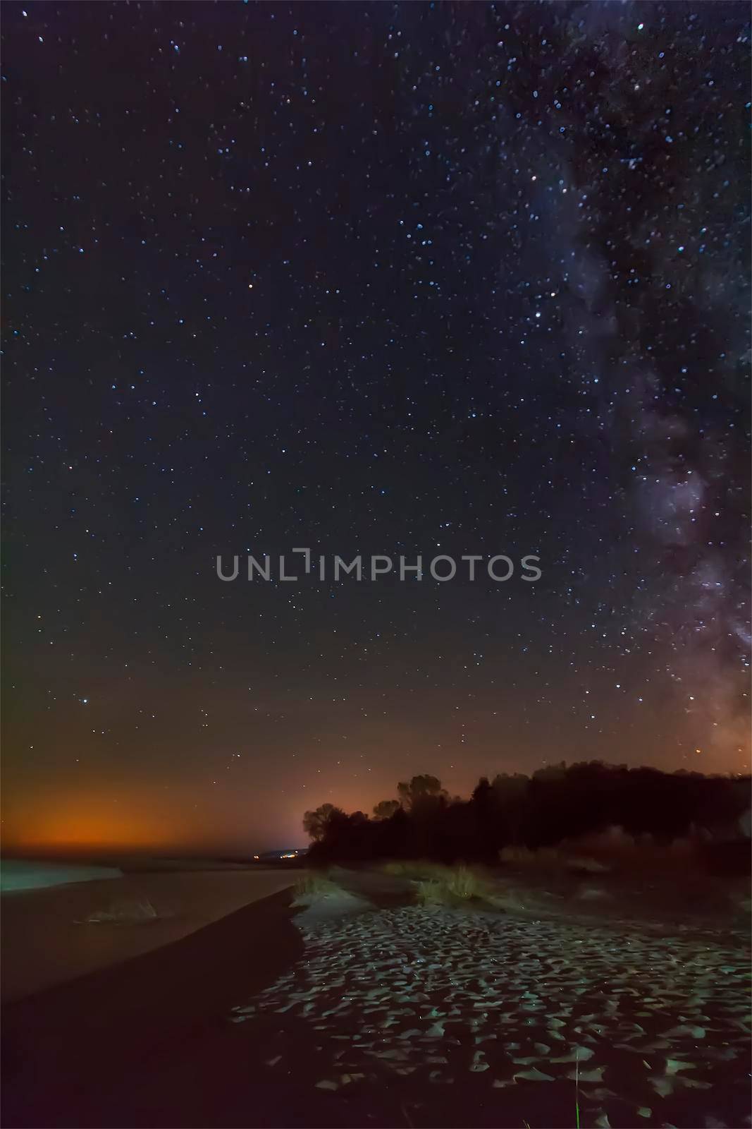 night sky with stars and milky way over beach