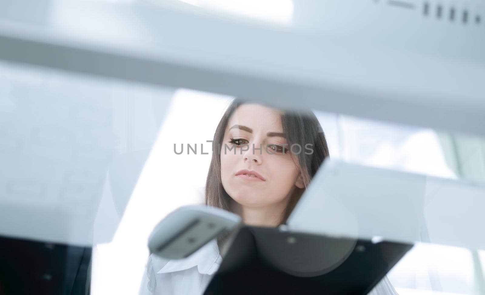 bottom view.young business woman reading a working paper.business concept