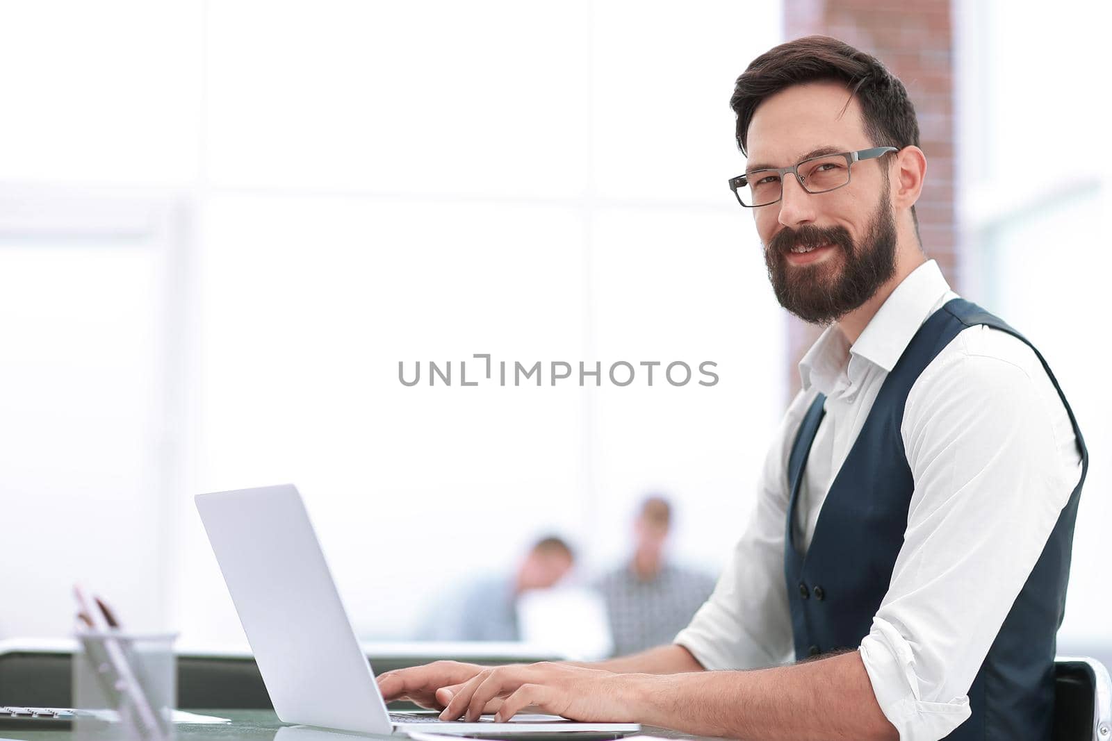 image of a businessman sitting at his Desk.photo with copy space