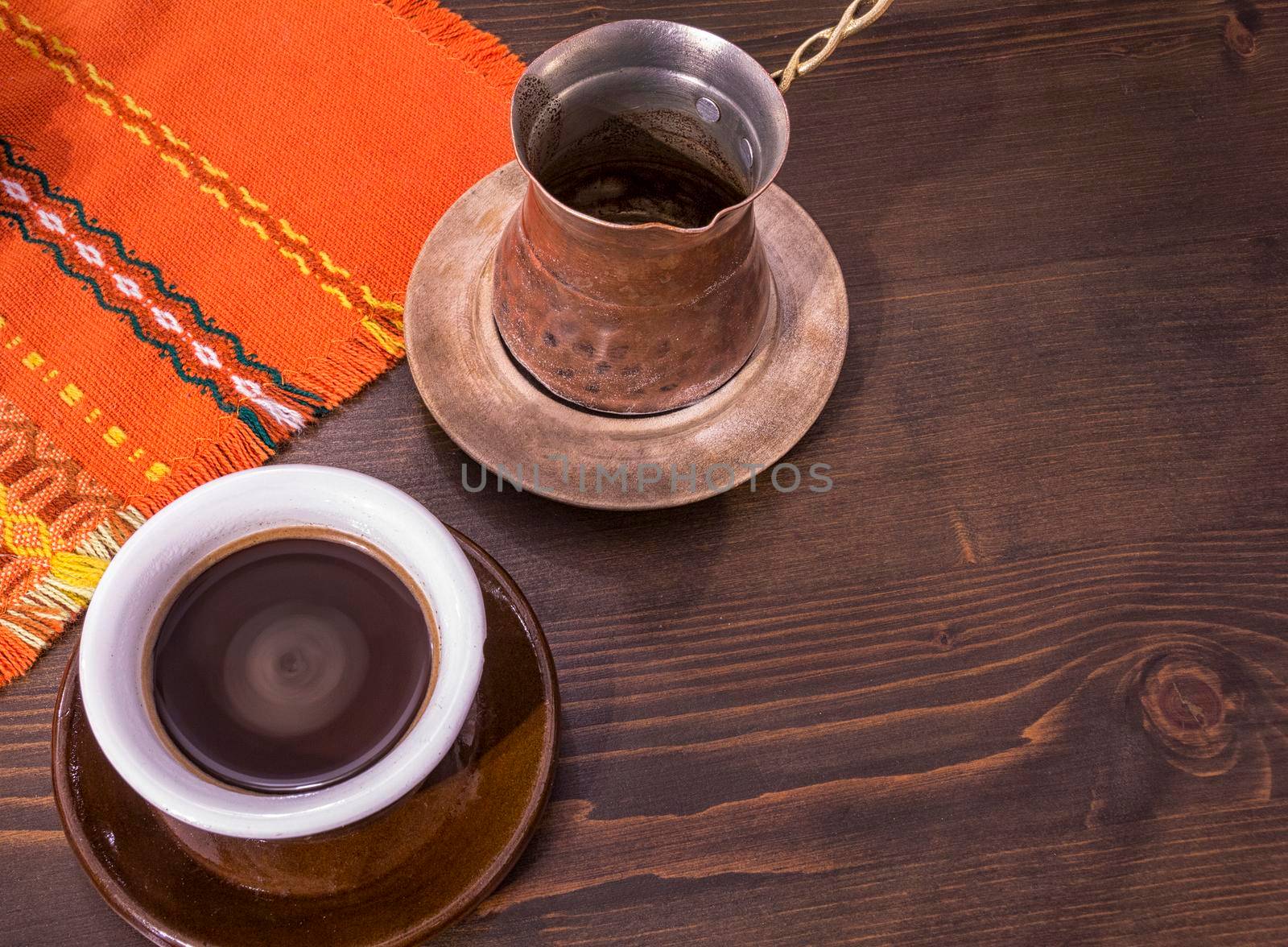 Coffee. Turkish coffee being made in a traditional way. Armenian Turkish coffee. The copper coffee pot and cup of coffee on the table. Traditional serving coffee