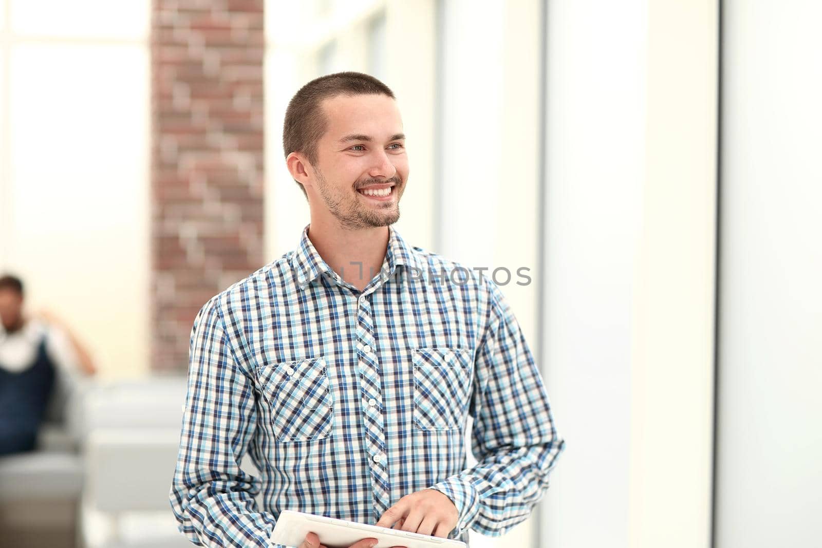 modern man standing near the office window .photo with copy space