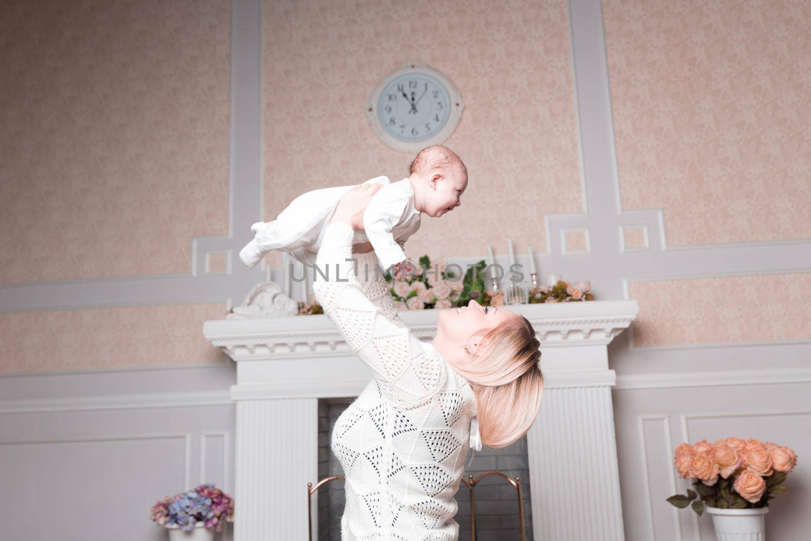 mom plays with the baby in the cozy living room. photo with copy space