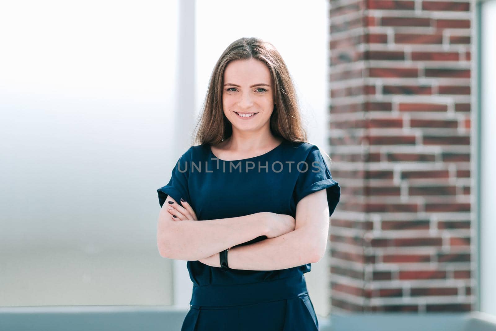 young business woman standing in office lobby by SmartPhotoLab