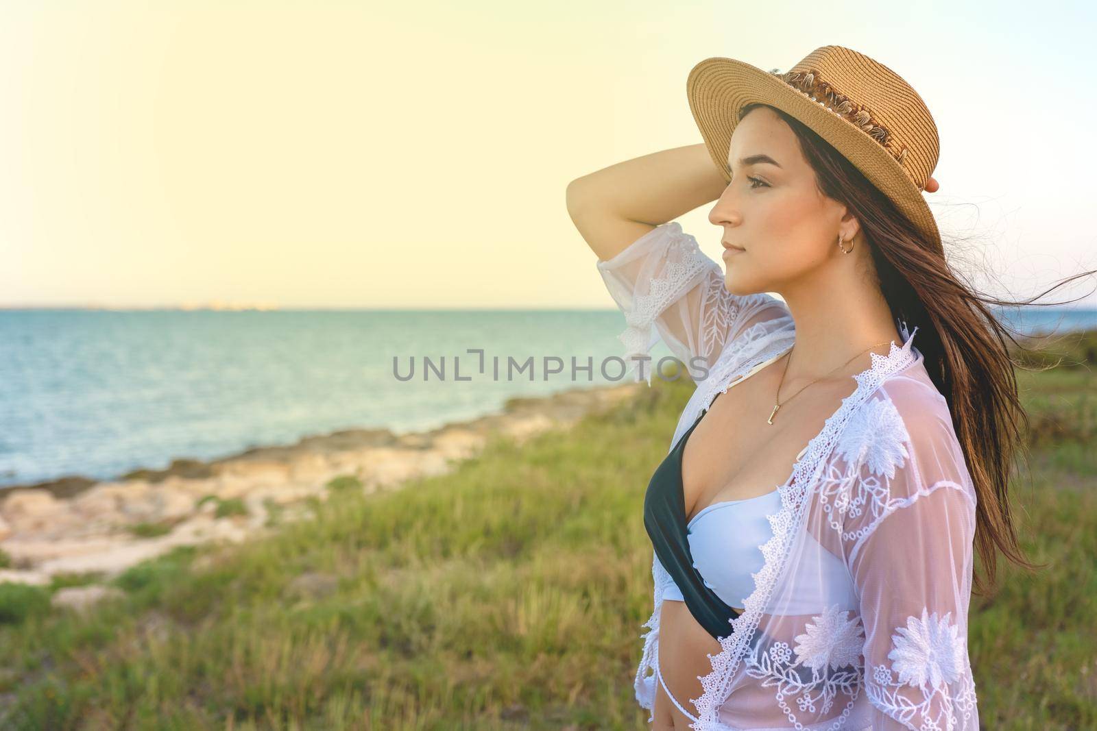 Happy traveller woman in white dress enjoys her tropical beach vacation. High quality photo