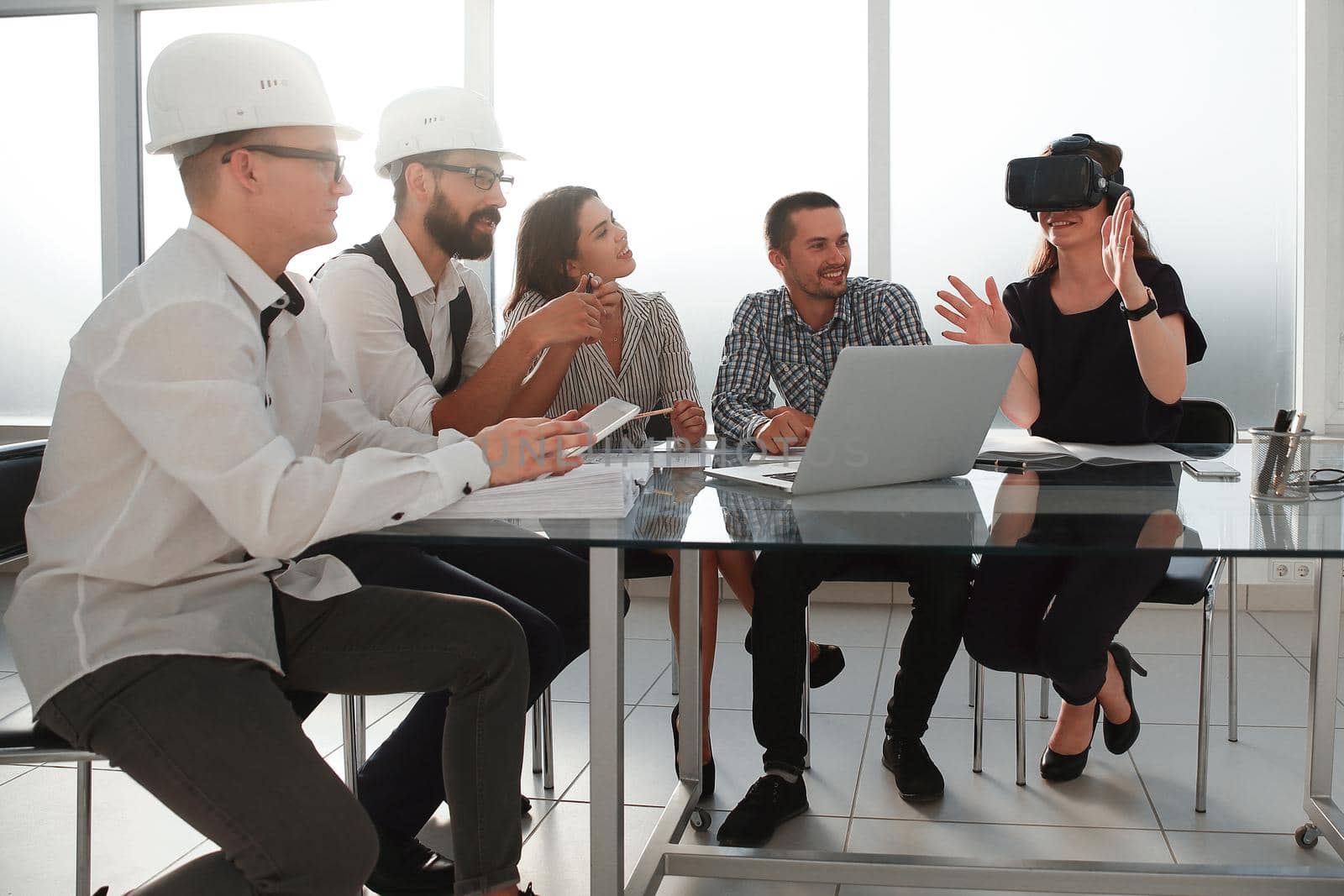 young designer in virtual reality glasses discussing her ideas with colleagues.people and technology