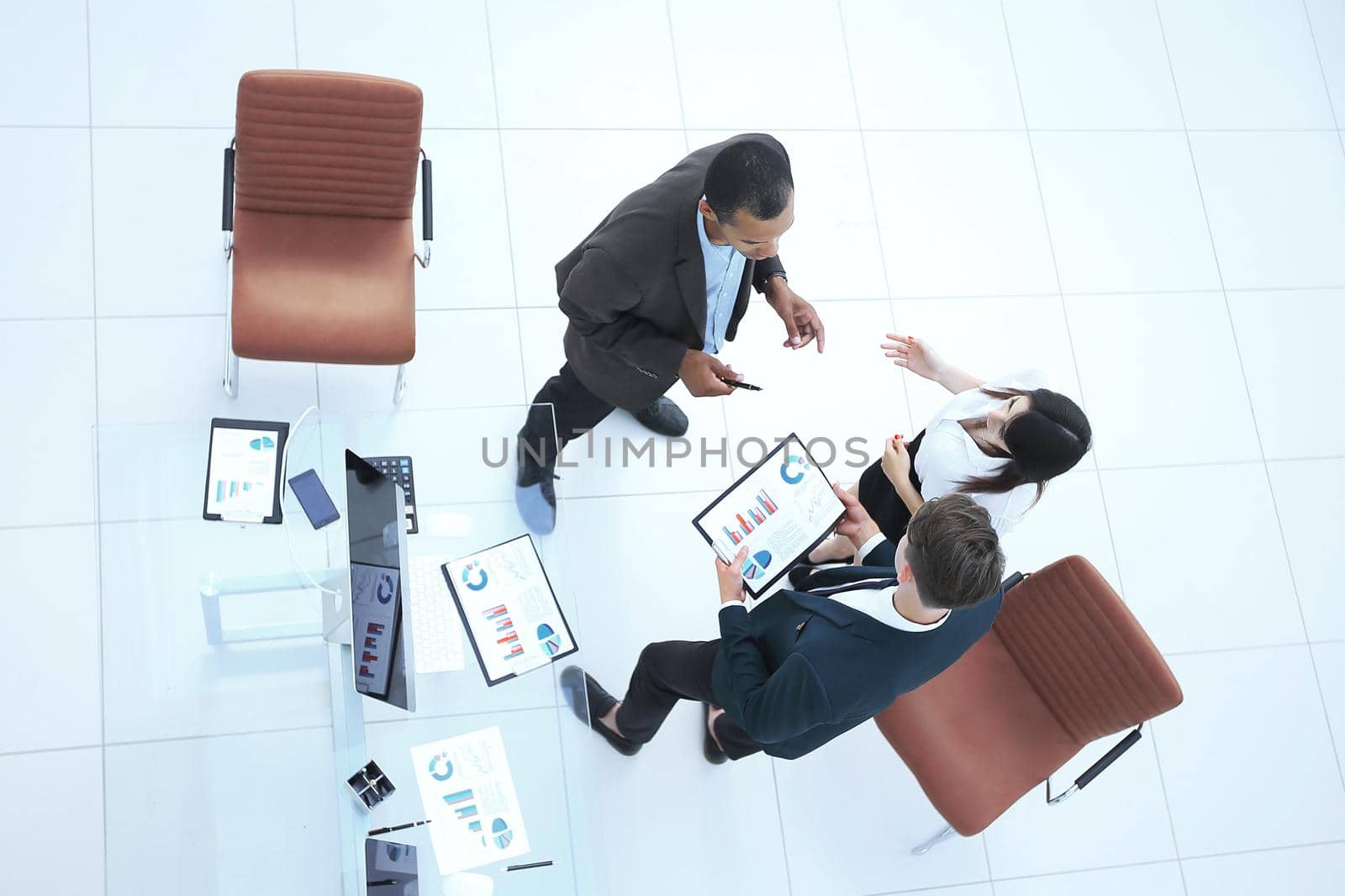 view from the top.business team discussing financial documents standing in the office