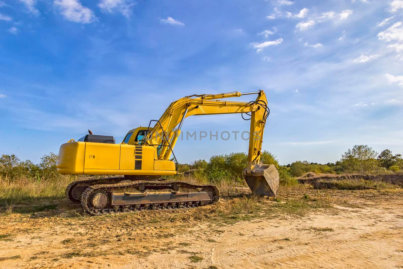 A stopping yellow excavator after work