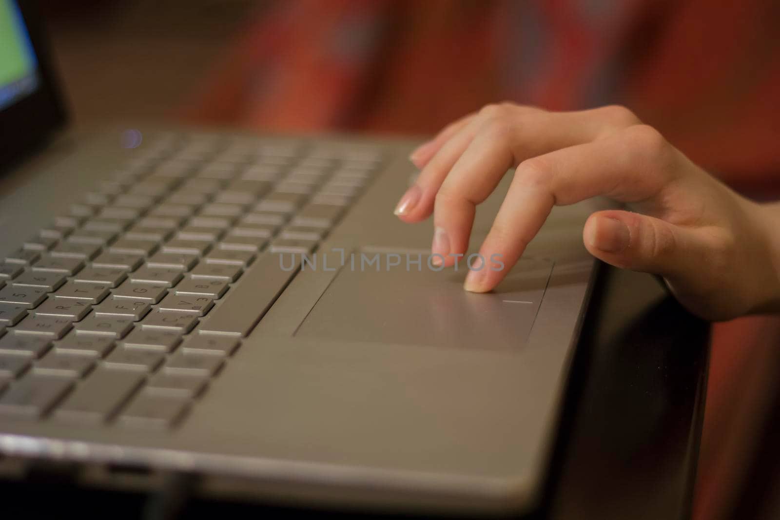 Woman working at home office hand on keyboard close up. Side view