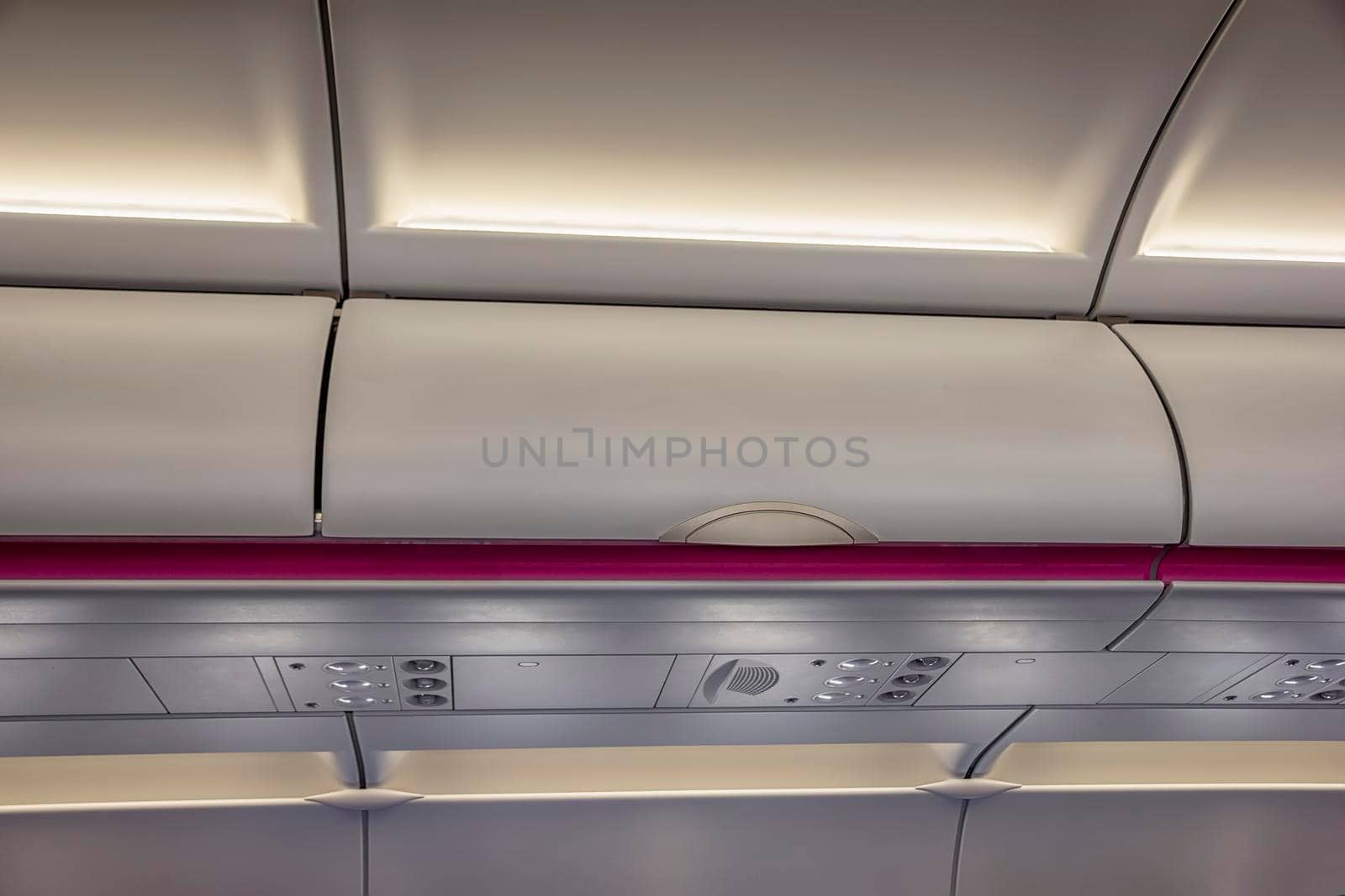 Luggage shelf in an airplane. Aircraft interior. Travel concept
