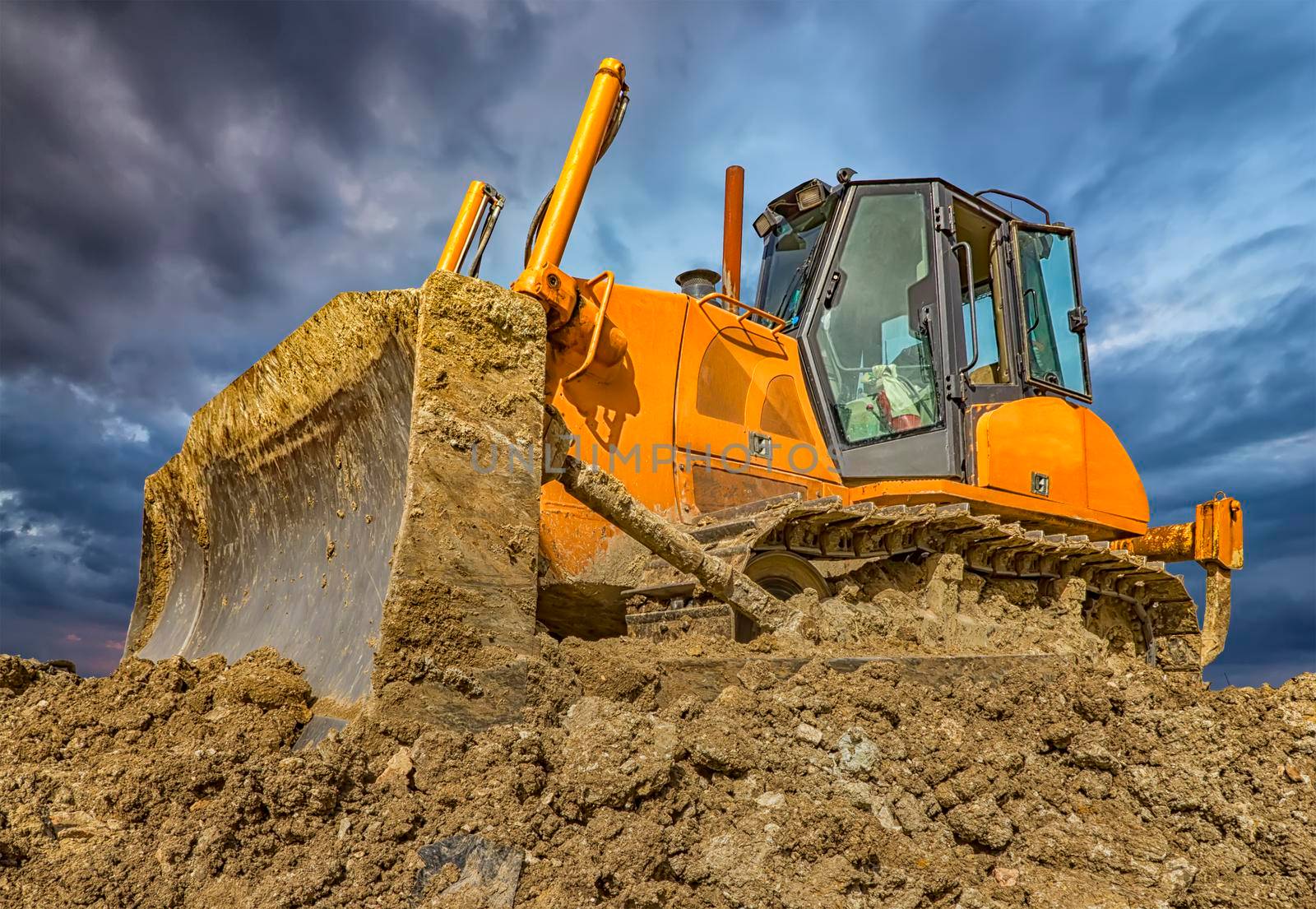 Amazing colorful view of stopped bulldozer and blade into the ground. Wide angle, close up
