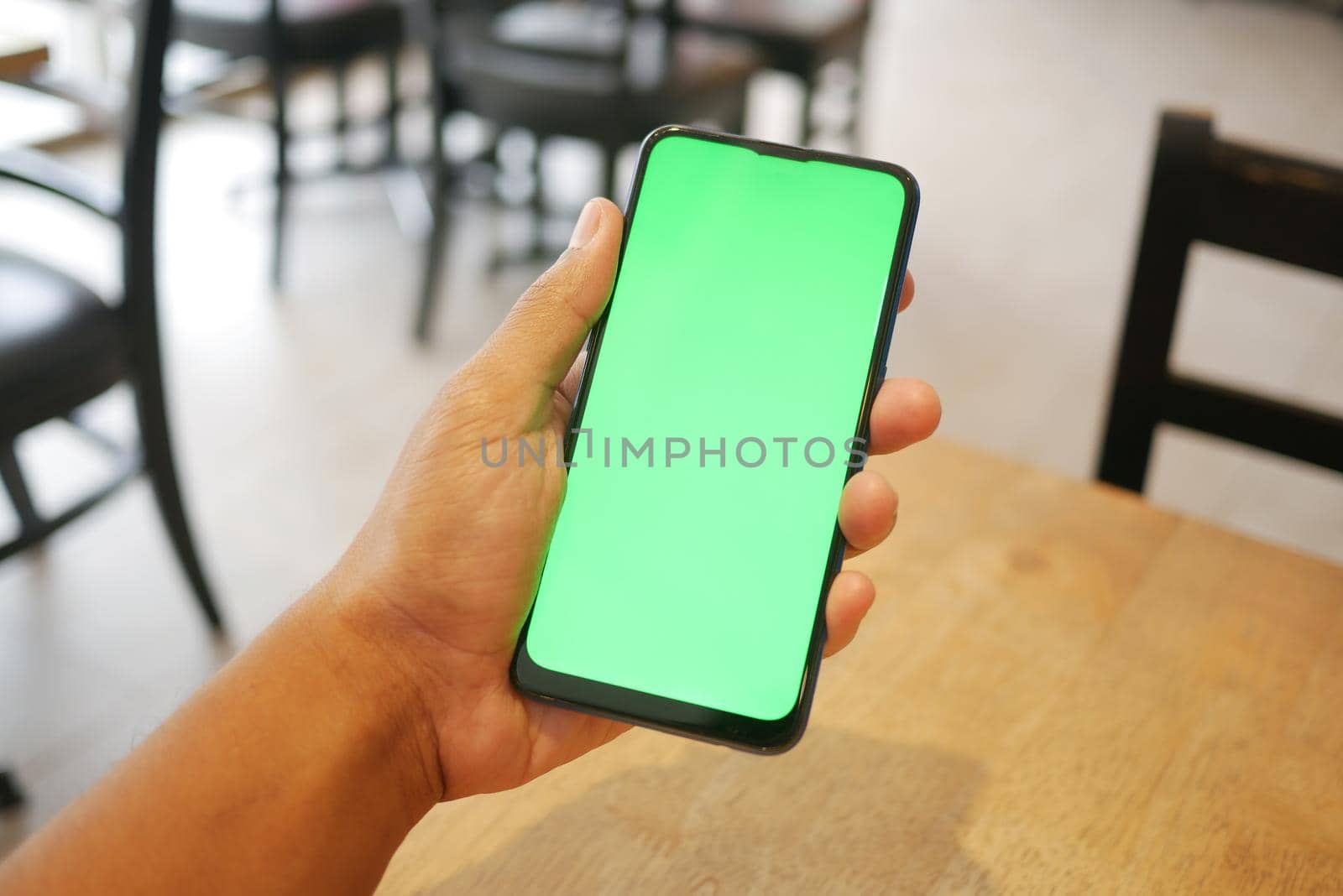 Close up of young man hand using smart phone