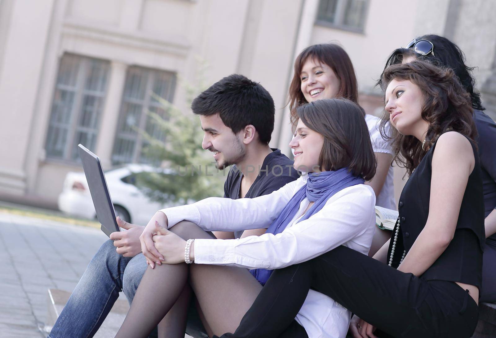 rear view. the group of friends of students with a laptop .education concept