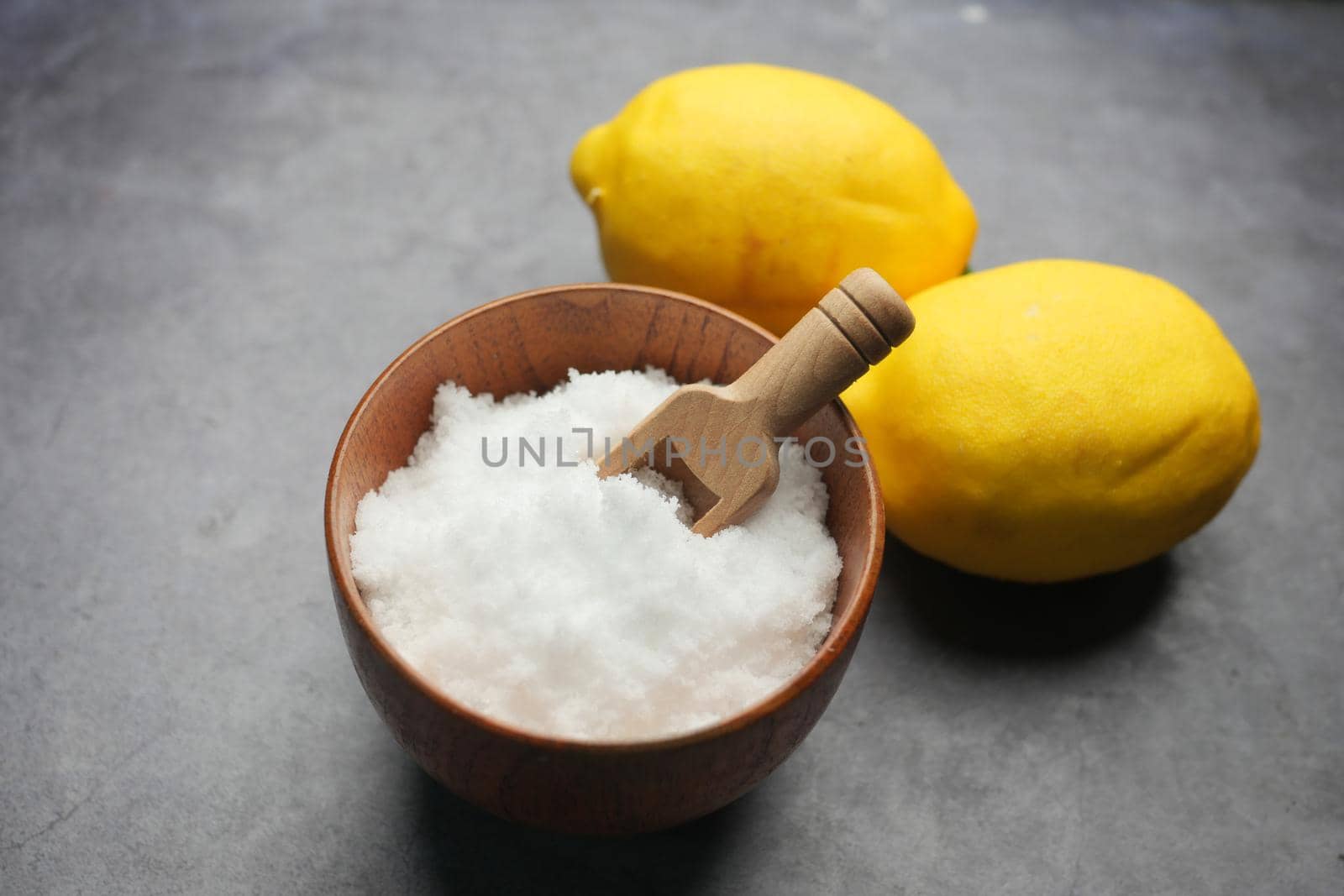 Coarse salt in a bowl on table .