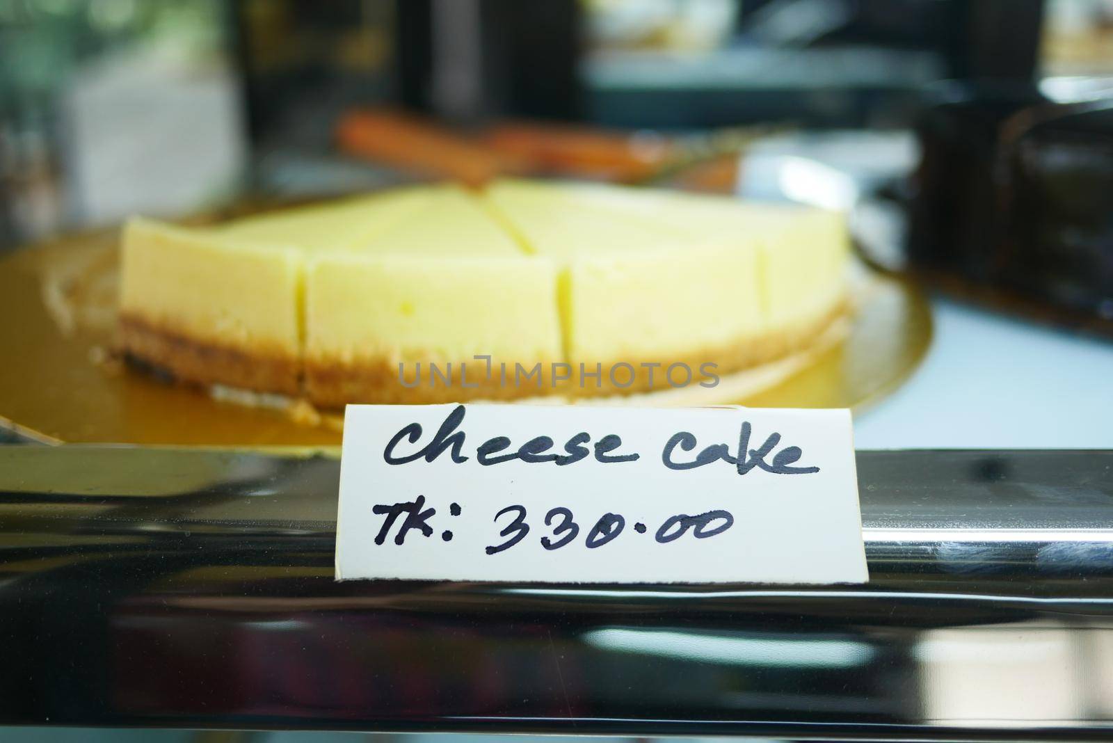 displaying slice of cheese cake at local store .