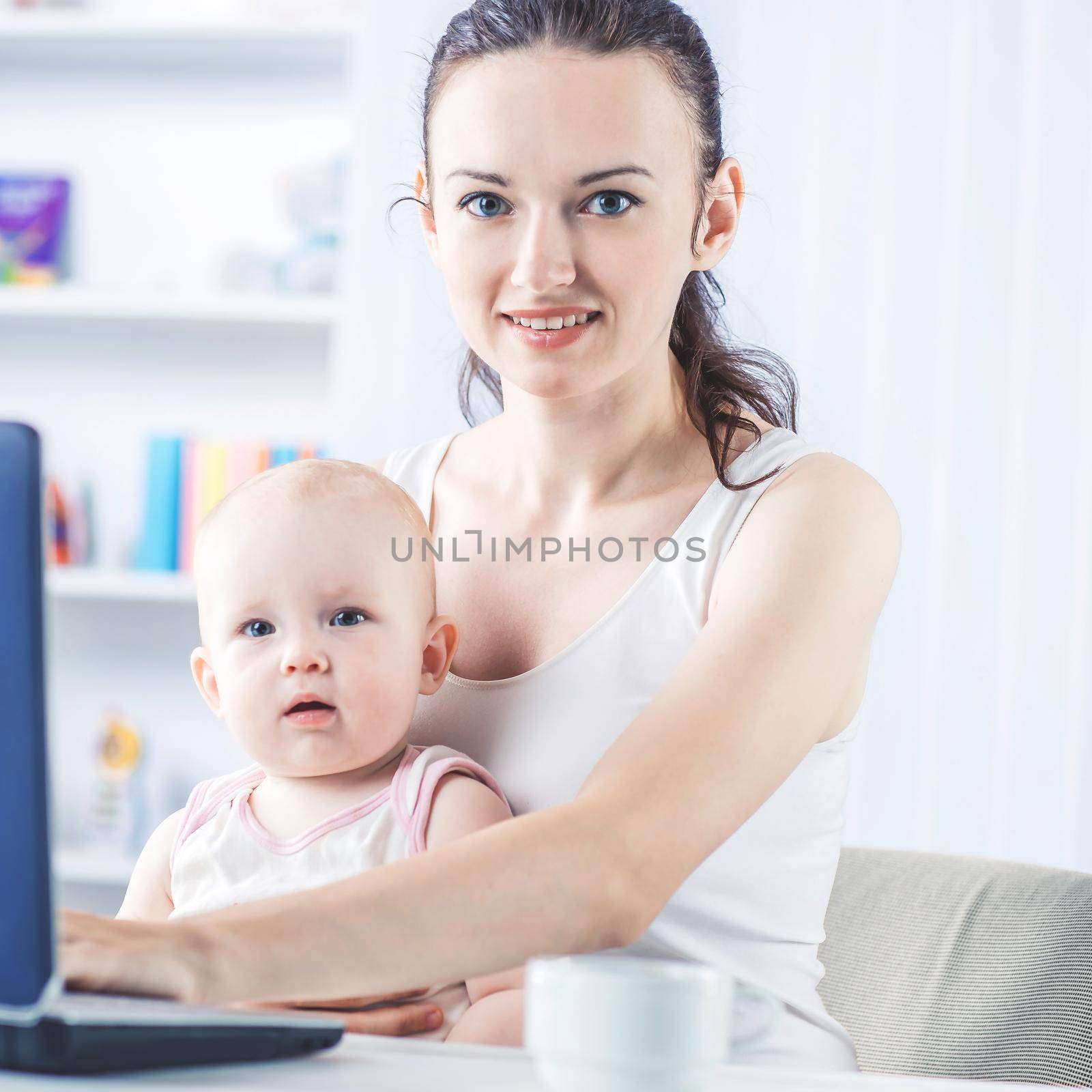 young mother and baby using laptop to communicate with grandma via skype by SmartPhotoLab