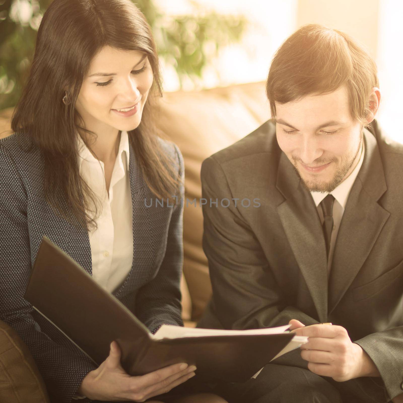 Image of business people listening and talking to their colleague at meeting in office