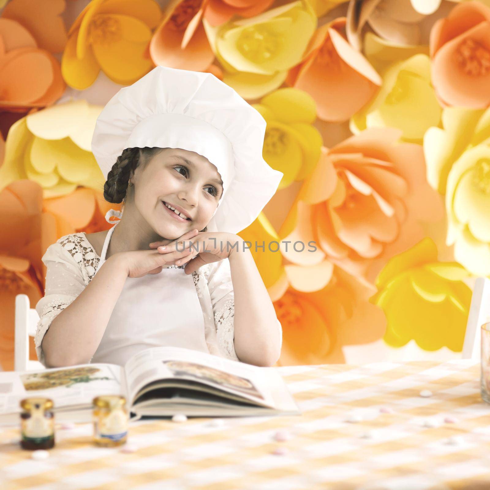 happy little girl with book chef preparing Breakfast