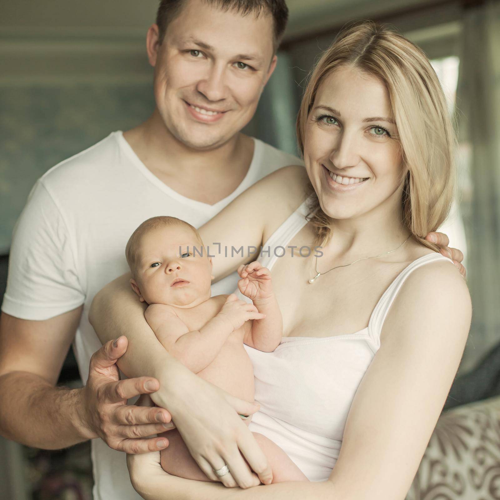 concept of family happiness - portrait of happy parents and newb by SmartPhotoLab
