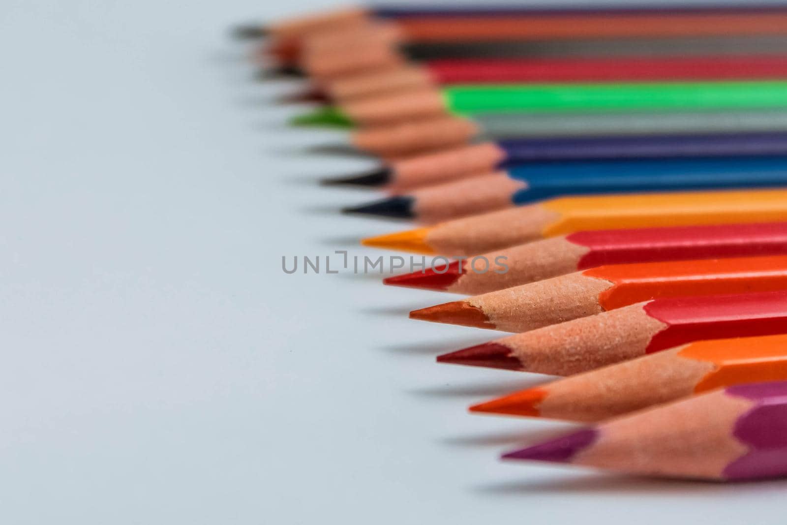 Row of multicolored wooden pencil collection isolated on white background