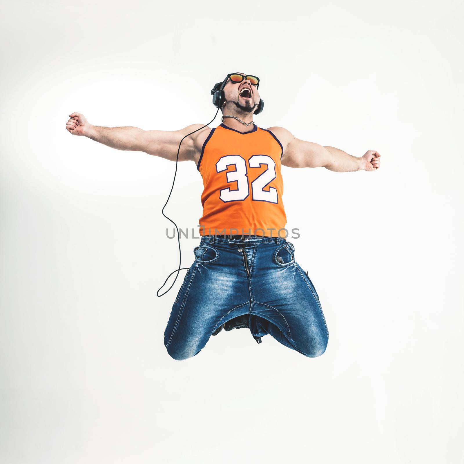 charming guy - rapper in headphones takes the dance break.photo on a white background and has an empty space for your text