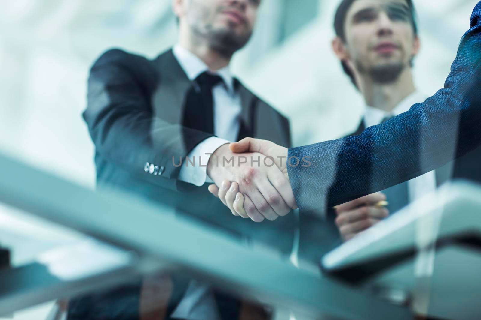 closeup of handshake of business partners on background of office