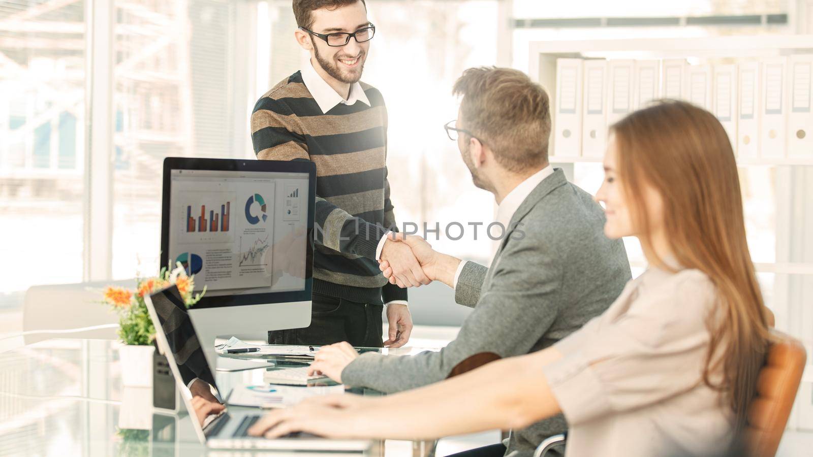 handshake of lawyers before the discussion of the financial conditions of the new contract between the new business partners.the photo has a empty space for your text.