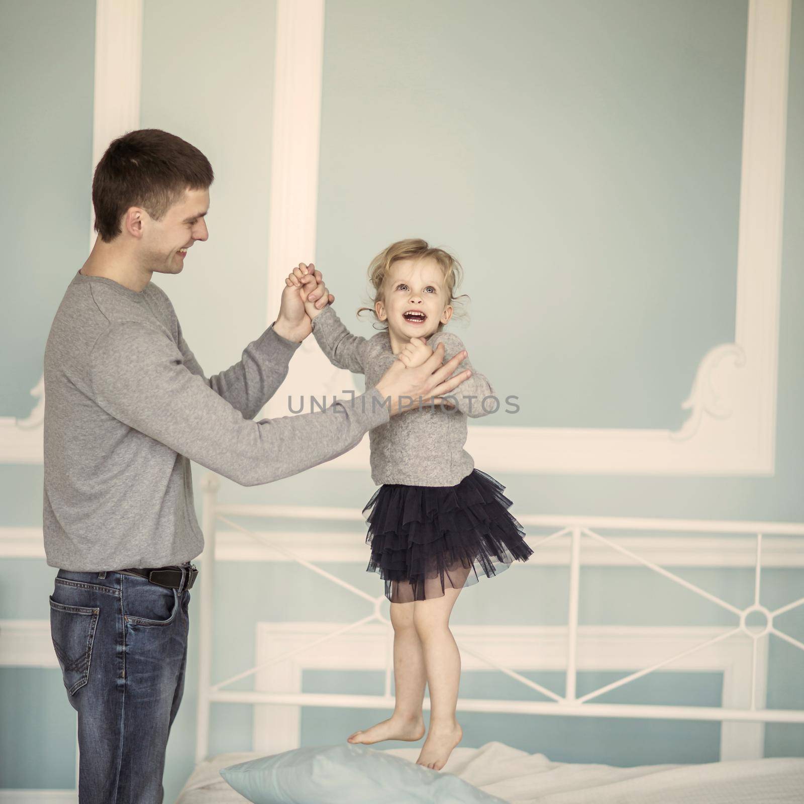 loving father plays with happy little daughter by SmartPhotoLab