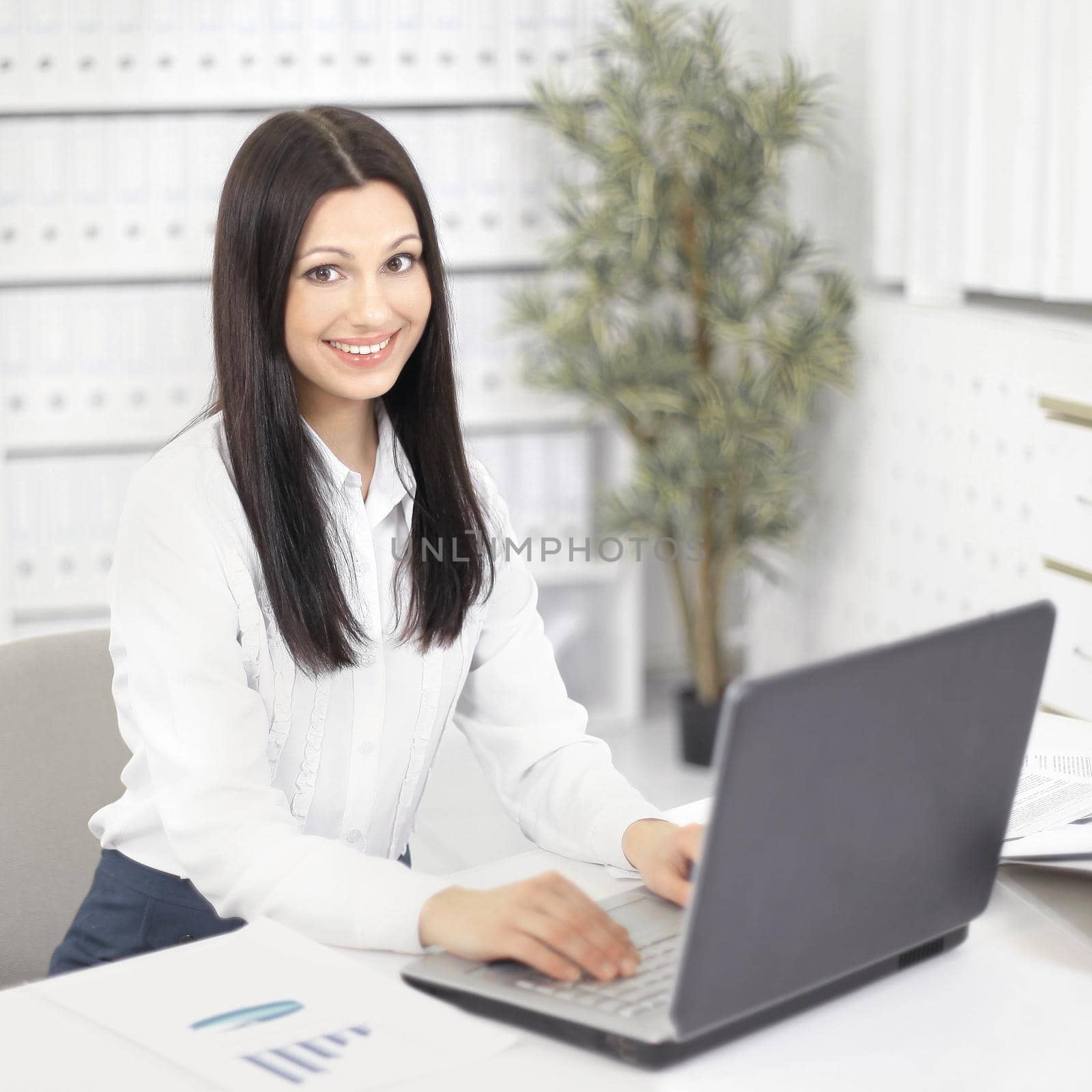 female assistant working on laptop in the office by SmartPhotoLab