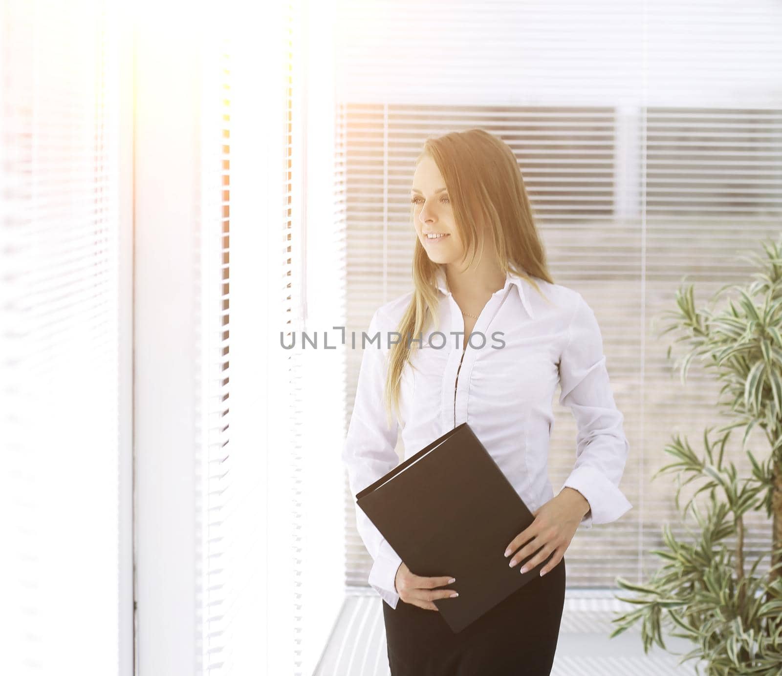 successful business woman with clipbord standing in a modern office.photo with place for text