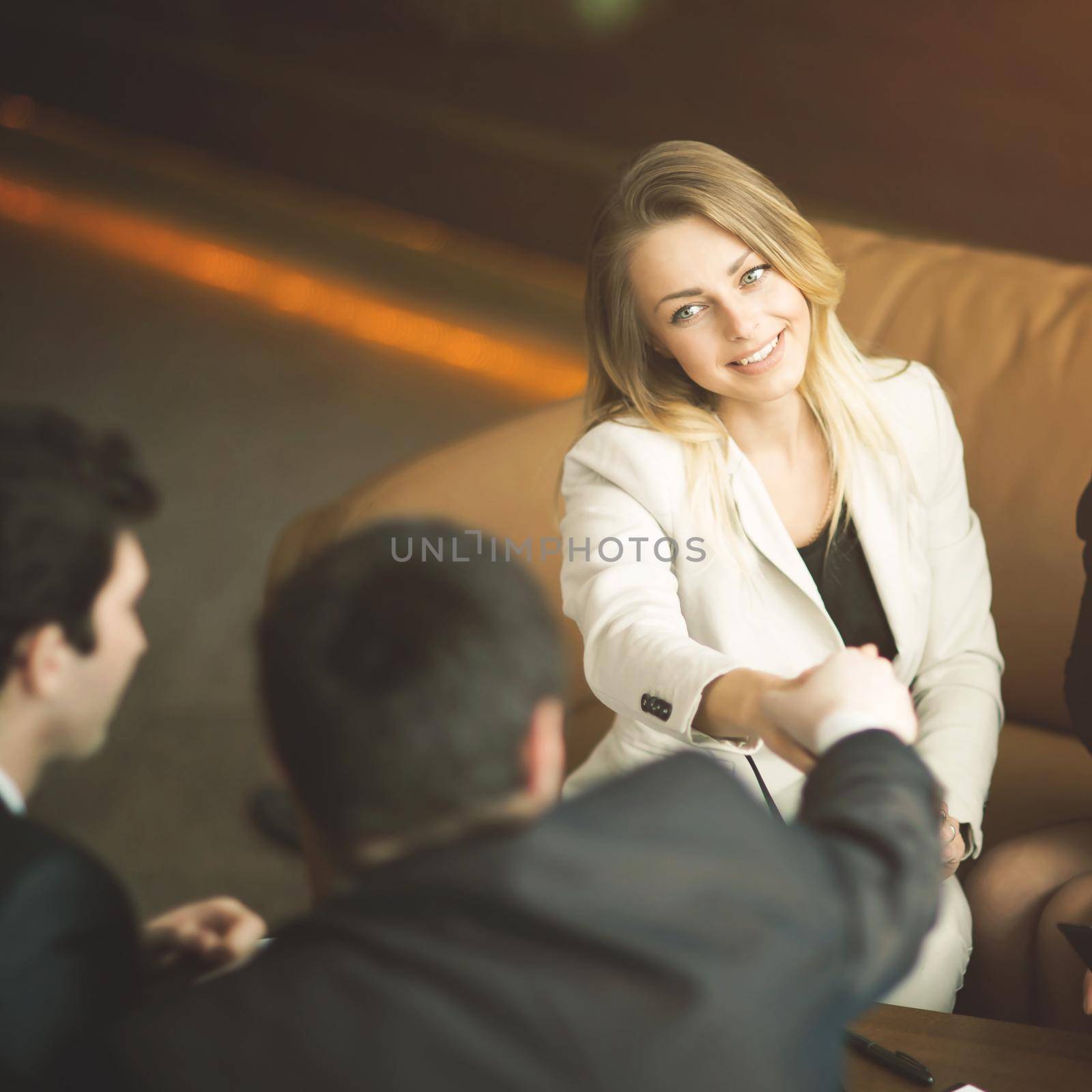 A diverse attractive man and woman business team handshake at office building