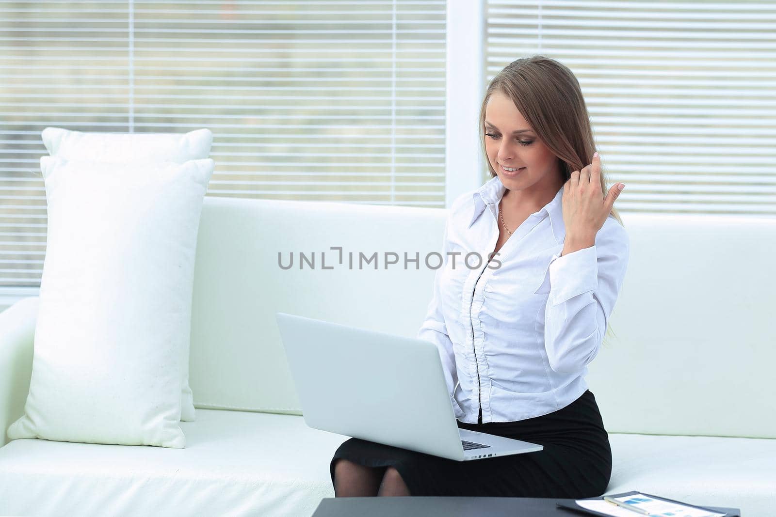 young business woman with laptop on the background of the office.photo with place for text