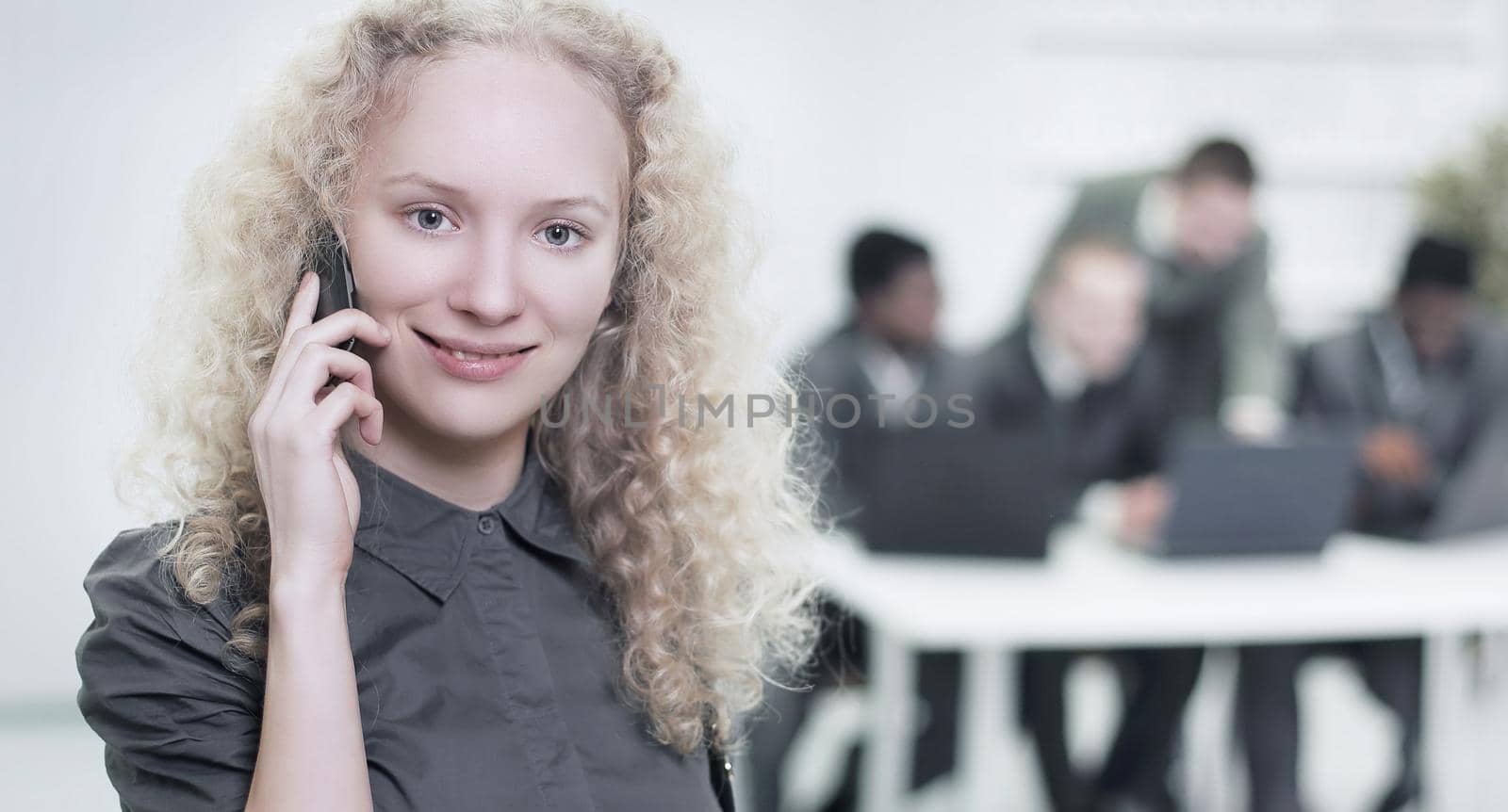 female assistant talking on mobile phone in office.photo with copy space