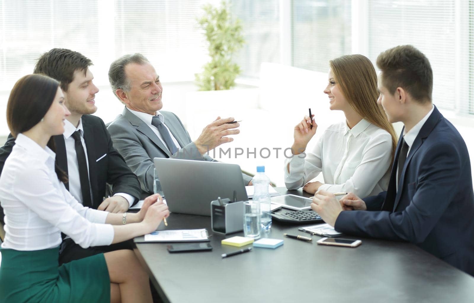 business colleagues talking at Desk in the office.the concept of teamwork