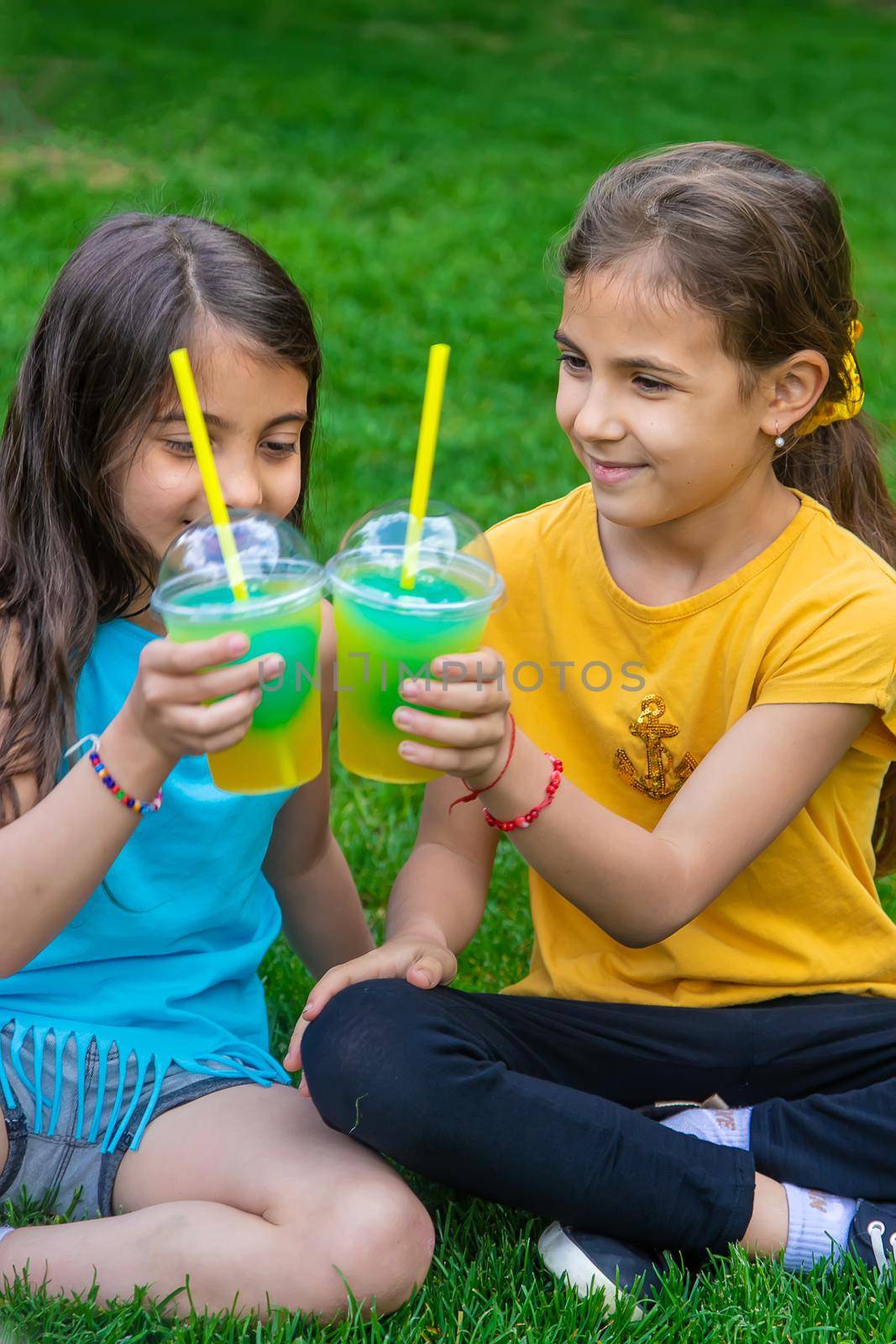 children drink a cocktail in the park. Selective focus. by yanadjana