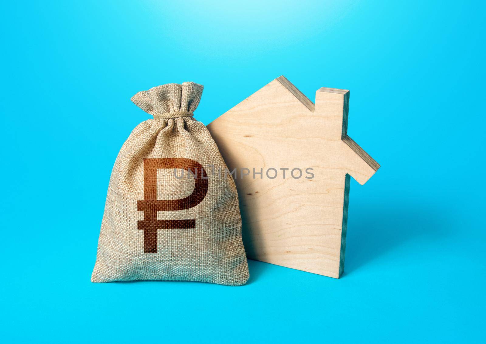 House silhouette and a russian ruble money bag. Mortgage loan. Realtor services. House project development. Rental business. Property appraisal. Home purchase, investment in real estate construction.