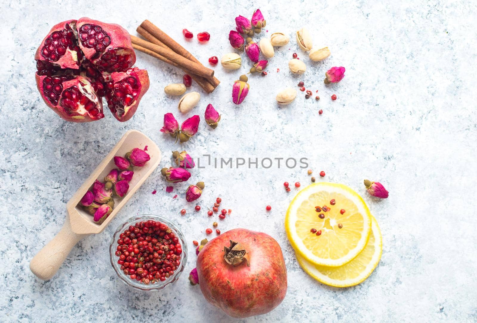 Arab ingredients, middle eastern food. Space for text. Arabic cuisine ingredients, white concrete background. Rose buds, spices, pomegranate, lemon. Halal food making. Top view. Arab food concept