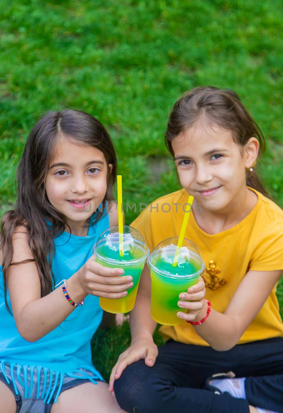 children drink a cocktail in the park. Selective focus. Kid.