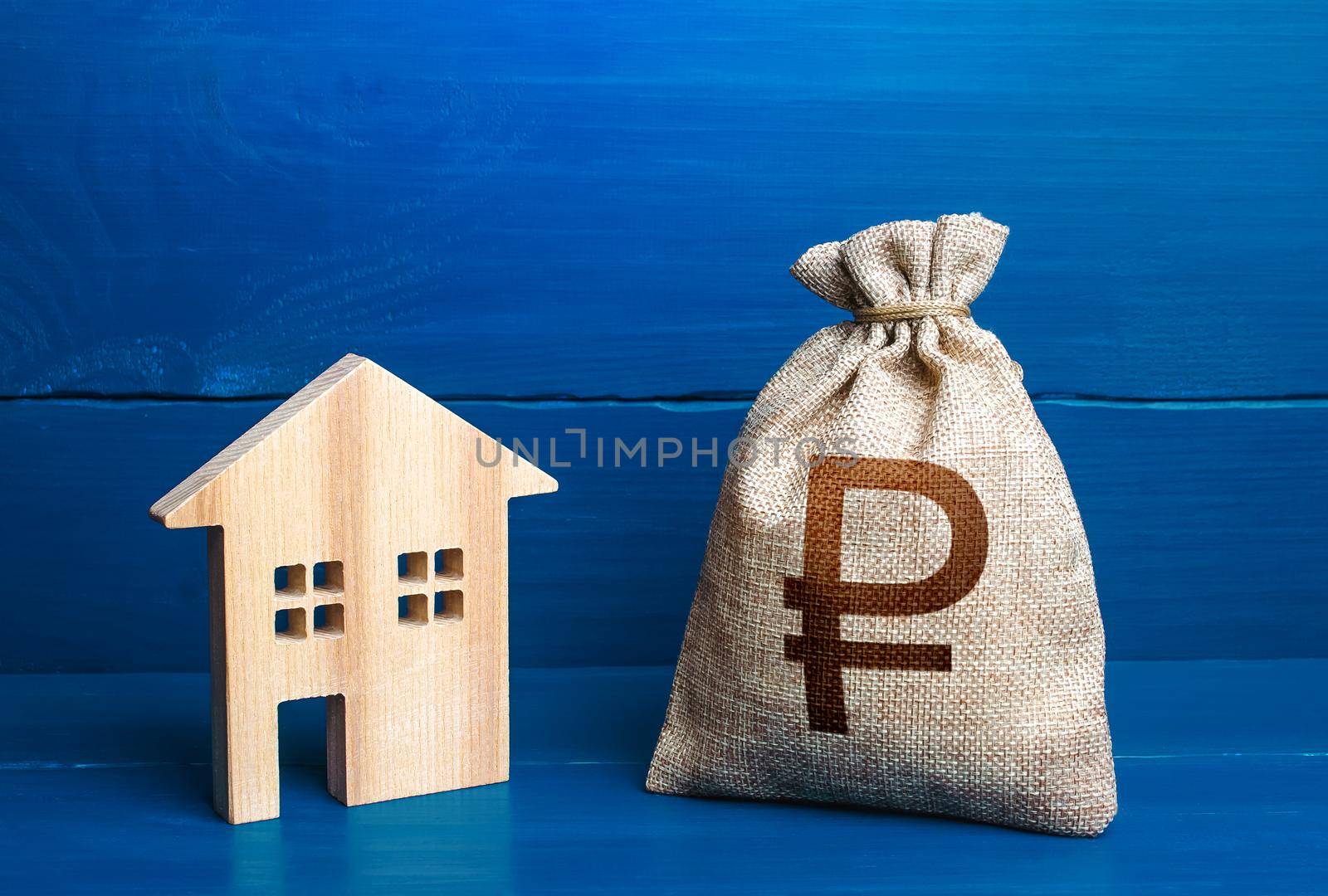 Figurine silhouette house and russian ruble money bag. Maintenance, property improvement. Mortgage loan. Sale of housing. Proposal for a deal price. First installment. Buying and selling real estate.