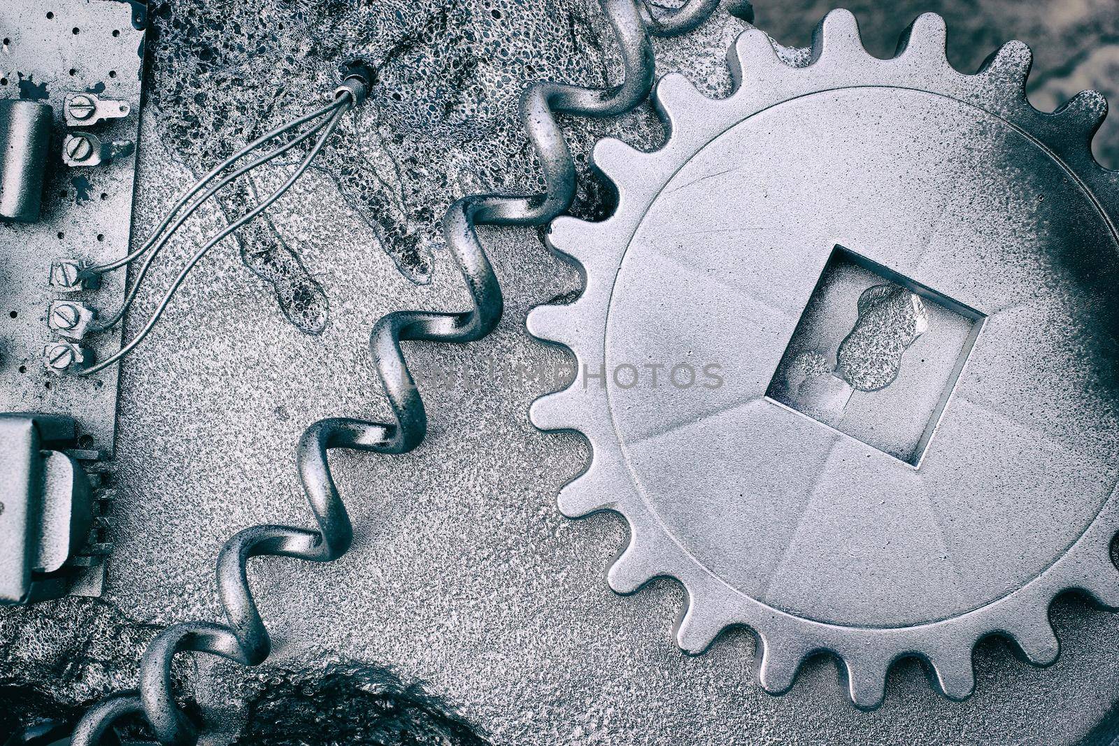 Silver grey grunge gears and wheels create an industrial steampunk background