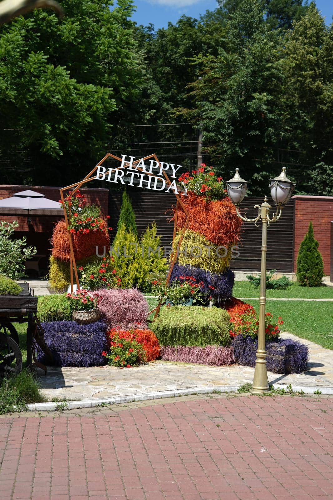 Happy birthday photo area made of natural hay bales painted in different colors by Serhii_Voroshchuk