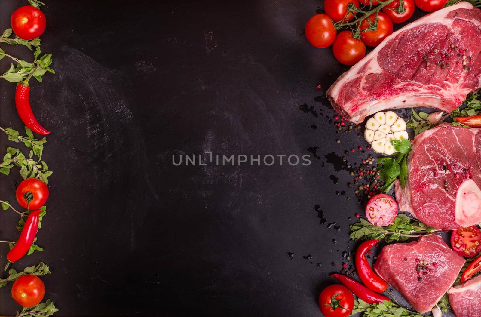 Raw meat steaks on a dark background ready to roasting by its_al_dente